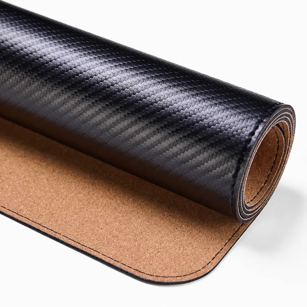 Aovela carbon fiber textured desk mat on a modern minimal desk