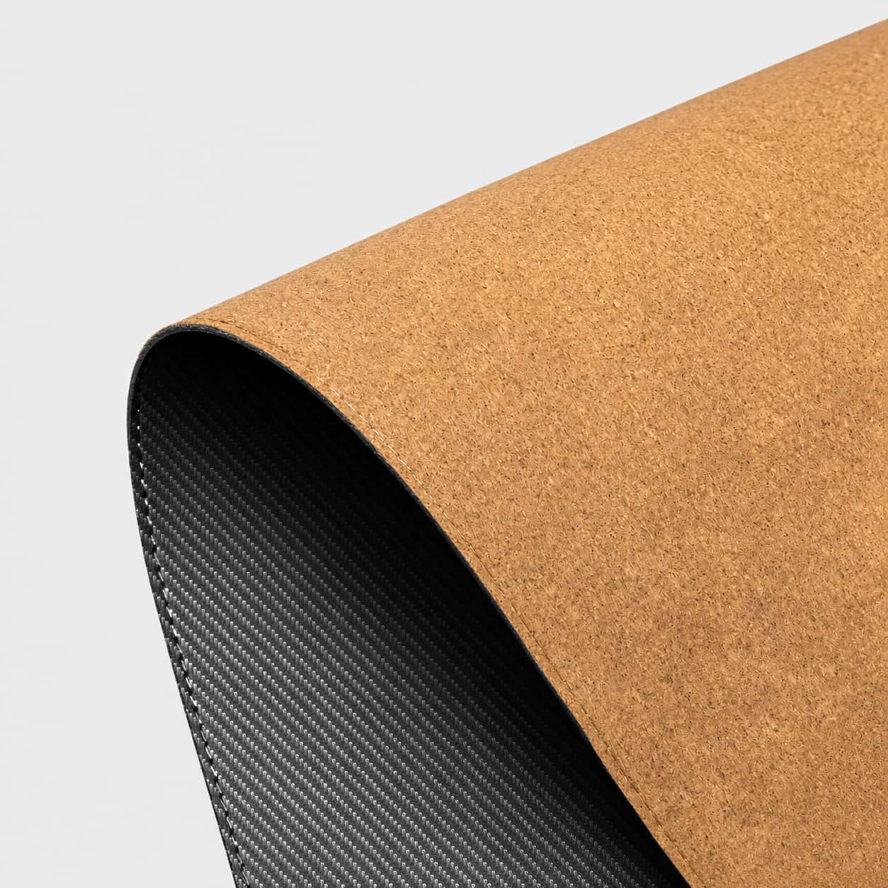 Aovela carbon fiber textured desk mat on a modern minimal desk