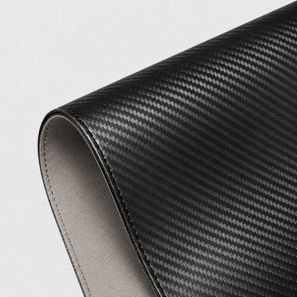 Aovela carbon fiber textured desk mat on a modern minimal desk