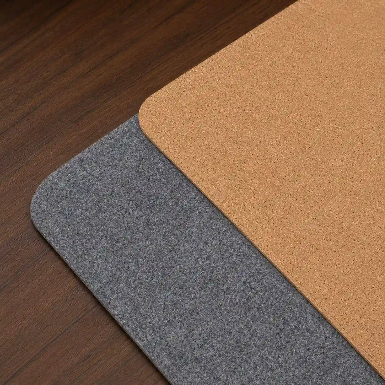 Aovela felt and cork double-sided desk mat on a warm wood home-office desk