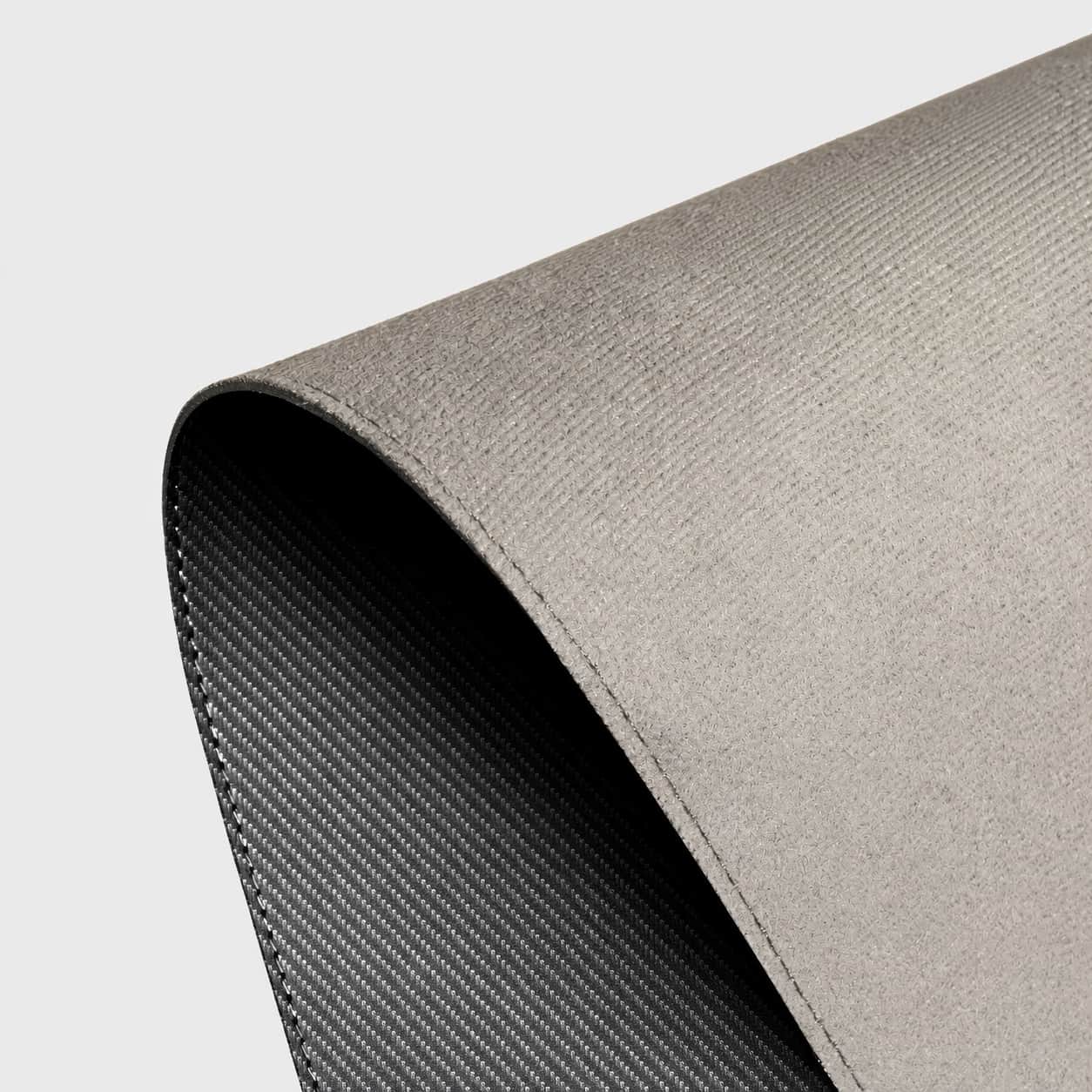 Aovela carbon fiber textured desk mat on a modern minimal desk